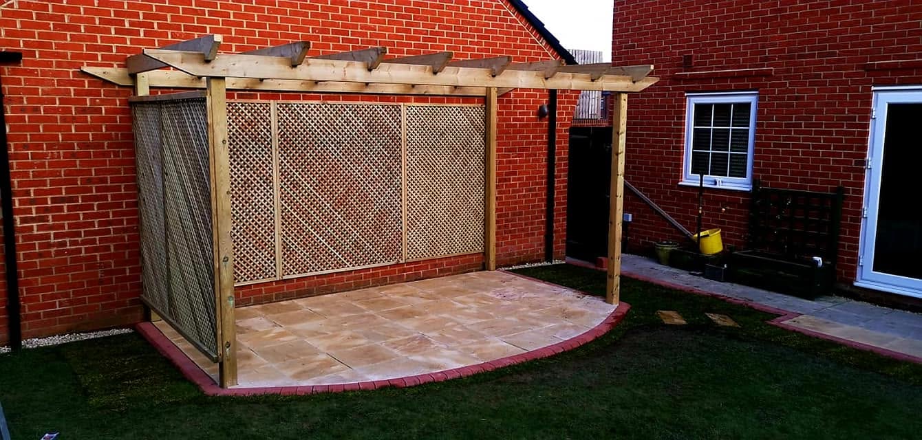 Patio area with wooden pergola and trellis screening